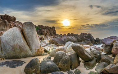 Abstract rocky beach with sunrise to greet the new day in the beautiful sea
