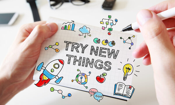 Try new things concept on white notebook 