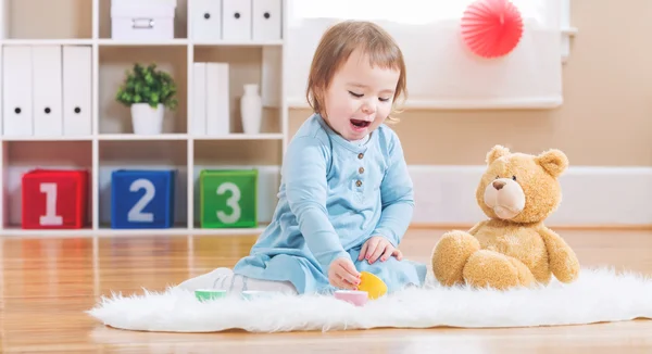 Toddler girl have tea with her teddy bear — Stock Photo, Image