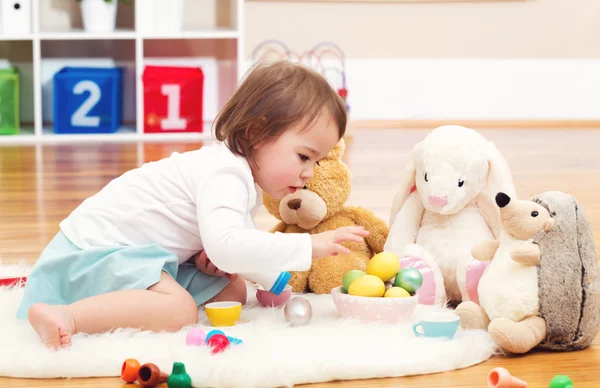 Toddler girl playing with her stuffed animals — Stock Photo, Image