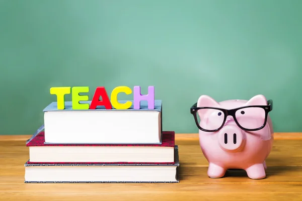 Teaching theme with pink piggy bank on top of books — Stock Photo, Image