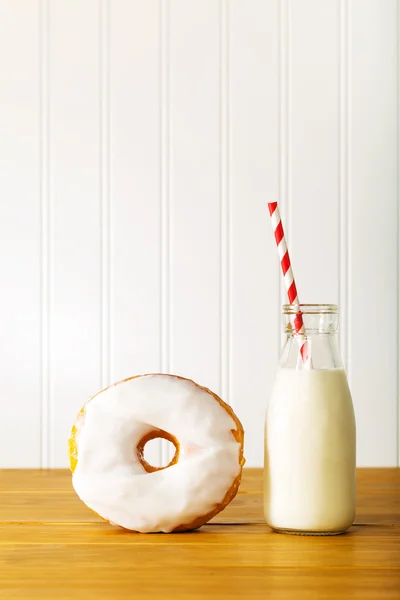 Wit geglazuurd donut met pot van melk — Stockfoto