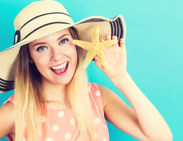 Giovane donna felice con in mano una stella marina — Foto Stock