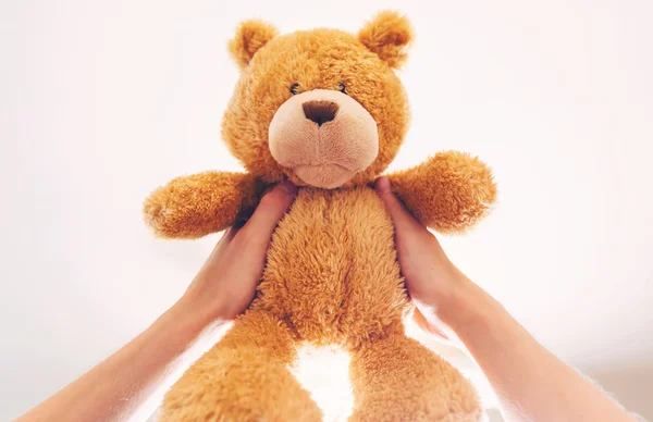 Holding up a teddy bear — Stock Photo, Image