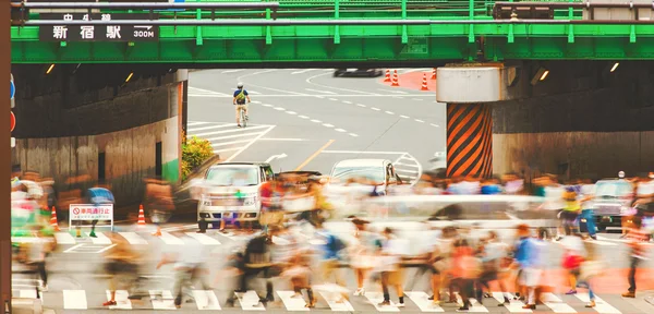 Motie wazig menigten overschrijding van een druk kruispunt in Tokio — Stockfoto