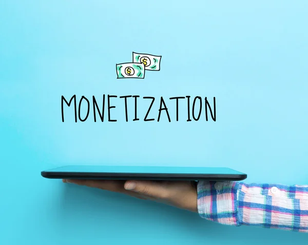 Monetarisering koncept med en surfplatta — Stockfoto