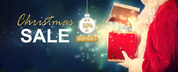 Christmas sale message with Santa opening a gift box — Stock Photo, Image