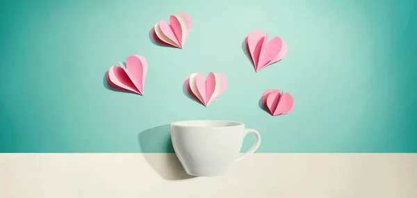 Coffee cup with paper craft hearts — Stock Photo, Image