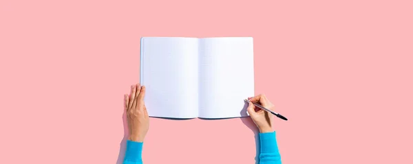 Persona escribiendo en un cuaderno — Foto de Stock