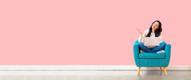 Dizüstü bilgisayarını kullanan genç bir kadın.