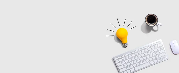 Computer keyboard with a yellow light bulb — Stock Photo, Image