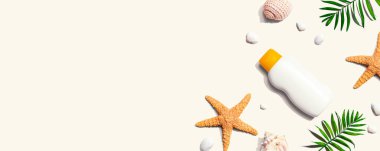 Deniz yıldızlı ve deniz kabuklu güneş kremi şişesi.