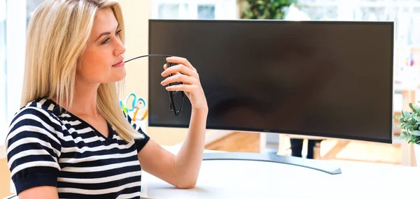 Young woman sitting at her desk