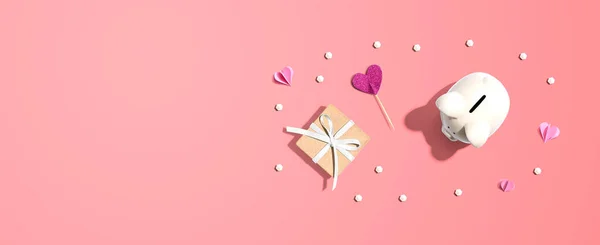 Hucha con una caja de regalo y corazones — Foto de Stock