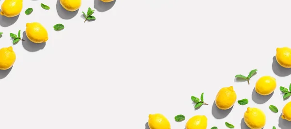 Fresh yellow lemons with mints overhead view — Stock Photo, Image
