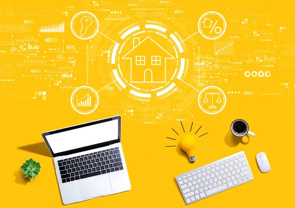 Real estate theme with computers with a light bulb — Stock Photo, Image