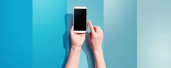 Person using a white smartphone — Stock Photo, Image