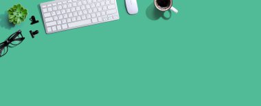 Bir fincan kahve ve gözlüklü bilgisayar klavyesi.