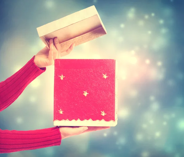 Woman holding red gift box — Stock Photo, Image