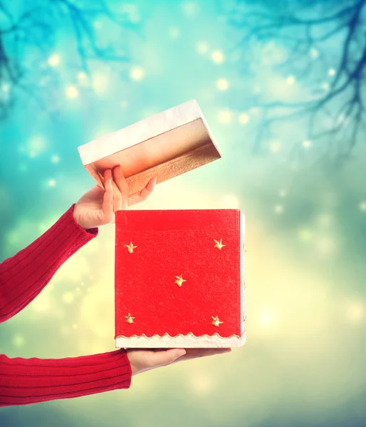 Woman holding red gift box — Stock Photo, Image
