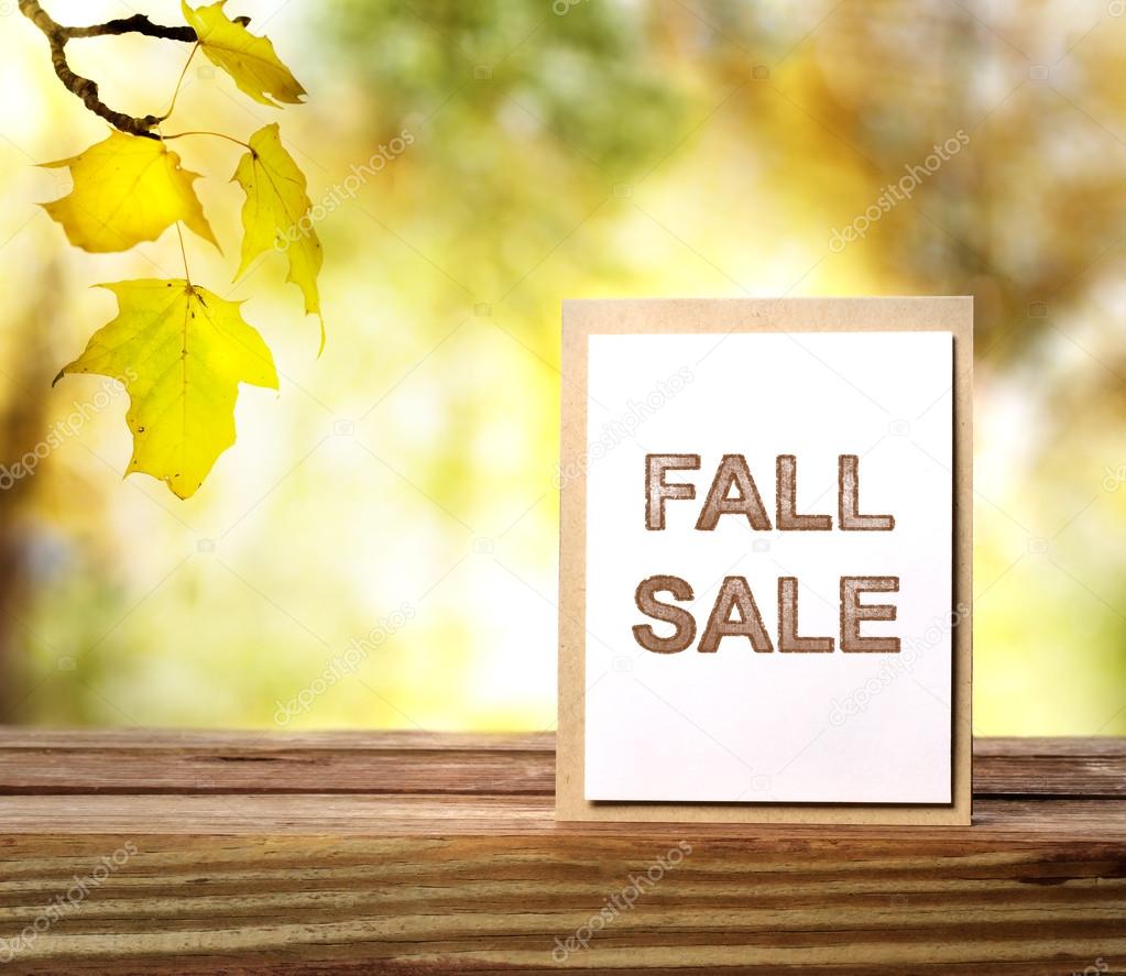 Fall Sale sign over yellow leaves background