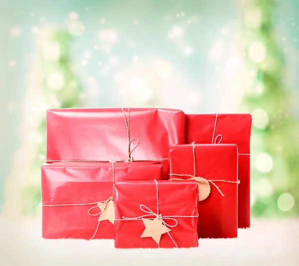 Gift boxes on christmas trees background — Stock Photo, Image