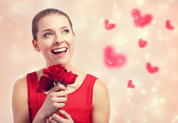 Young woman holding red roses — Stock Photo, Image