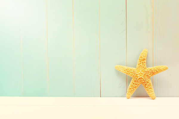 Starfish on a teal wooden background