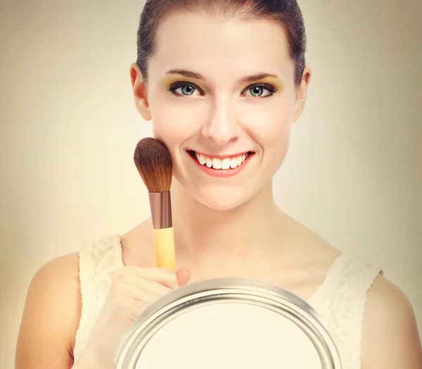 Beautiful woman with makeup brush — Stock Photo, Image