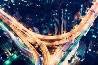 Aerial-view highway junction at night in Tokyo clipart