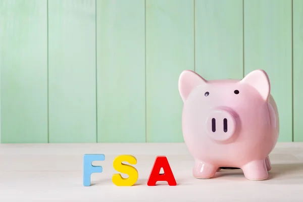 FSA theme with block letters and a piggy bank — Stock Photo, Image