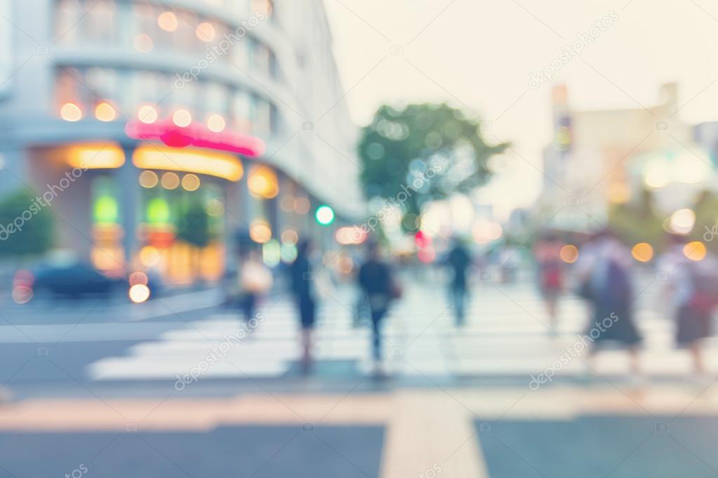 Blurred street intersection in a city with people