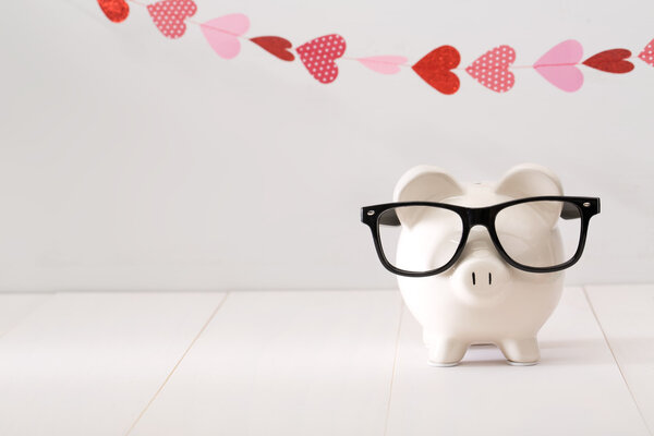 Piggy bank wearing black glasses