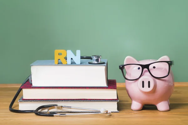 Registered Nurse RN theme with pink piggy bank with chalkboard — Stock Photo, Image