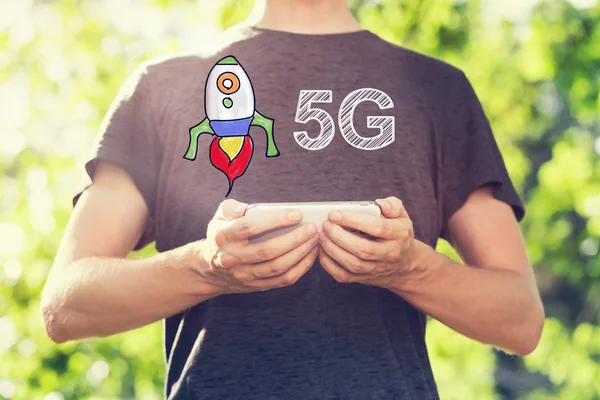 Conceito 5G com o homem segurando seu smartphone fora — Fotografia de Stock