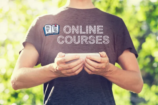 Online Courses concept with man holding his smartphone — Stock Photo, Image