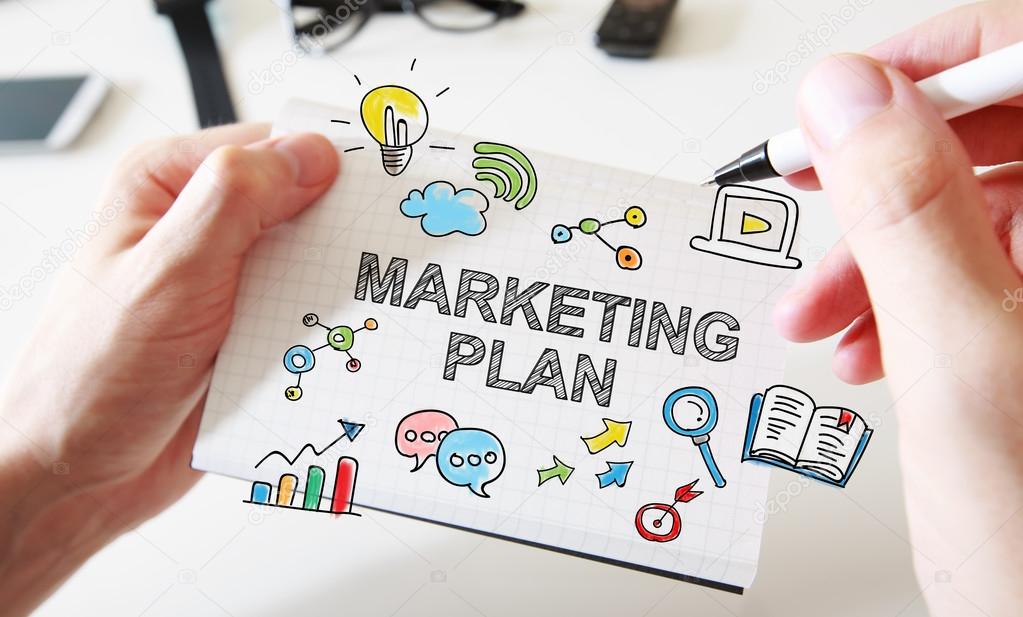 Mans hand drawing Marketing Plan concept on notebook