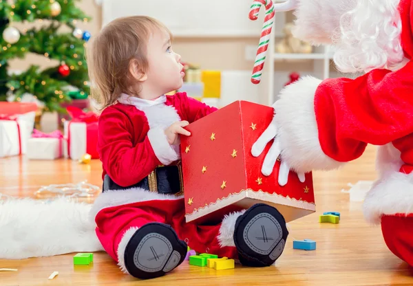 Toddler girl receiving a gift from Santa Claus — Stock Photo, Image