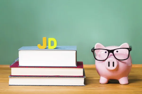 Juris Doctor Law degree theme with piggy bank — стоковое фото