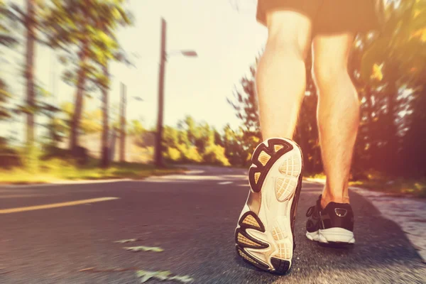 Athlete man jogging outside at sunset — Stock Photo, Image