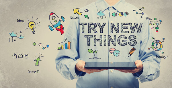 Try New Things concept with man holding a tablet