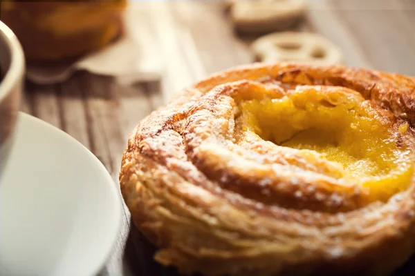 Danish on a rustic table with coffee — Stock Photo, Image