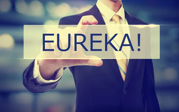 Uomo d'affari che detiene Eureka — Foto Stock