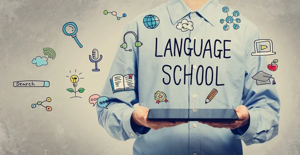 Concepto de escuela de idiomas con el hombre sosteniendo una tableta — Foto de Stock