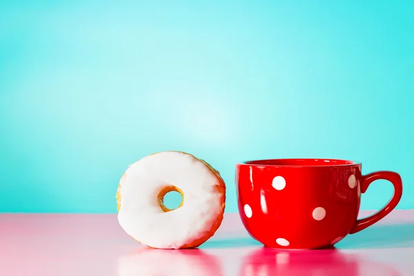 White donut with big red mug