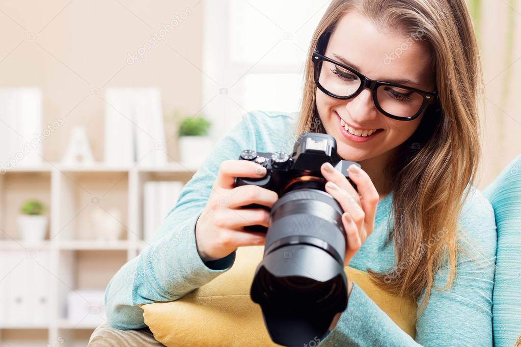 Young female photographer with camera 