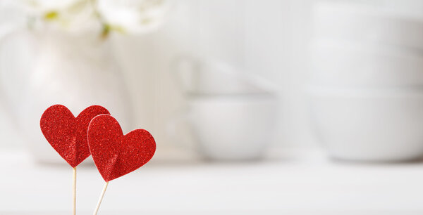 Small red hearts with white porcelain dishes