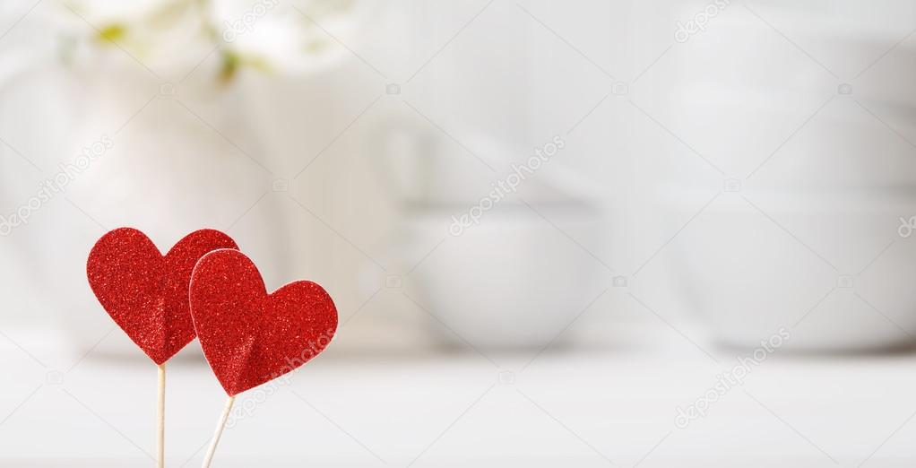 Small red hearts with white porcelain dishes