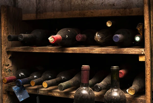 old wine cellar with dusty wine bottles