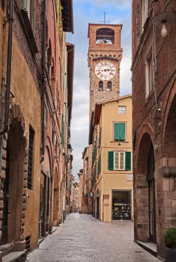 Lucca, Tuscany, Italy: the main street of the old town Via Fillungo with the medieval clock tower Torre delle Ore or Torre dell'Orologio